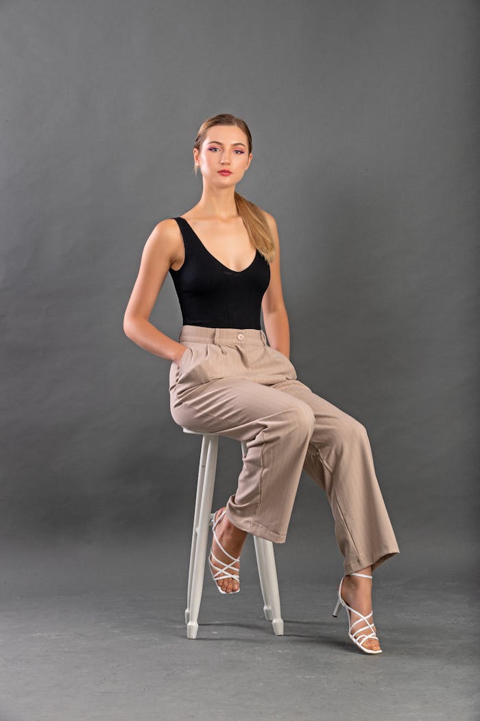 Stylish fashion model posing in a studio, showcasing modern elegance and poise.